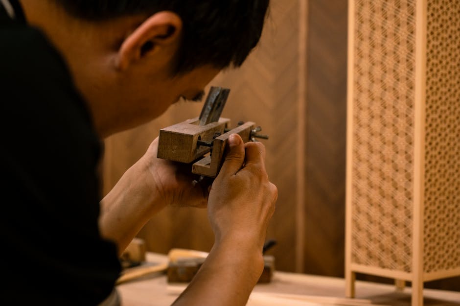 Master craftsman sanding a piece of handmade custom furniture